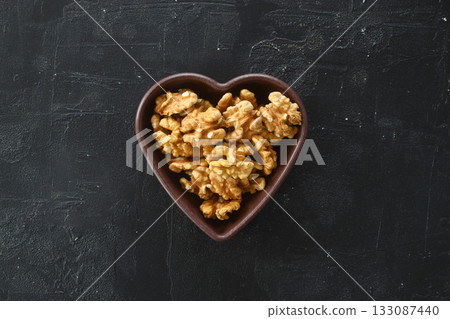 Inshell walnuts in a heart-shaped plate. Heart Nuts, Heart Health Products, Structured Walnuts Healthy food protein 133087440