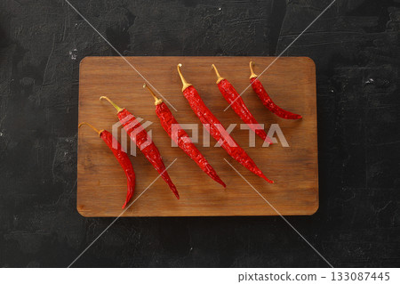 fresh chili peppers on black background,ripe red chili peppers. Top view. Mexican cuisine fresh chili peppers on black background,ripe red chili peppers. Top view. Mexican cuisine 133087445