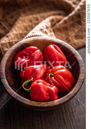 Red chili pepper habanero in bowl on wooden table. 133087630