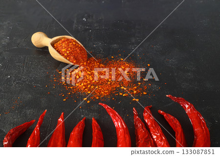 cayenne pepper on wooden spoon spices and dried chilli peppers background group of red hot chilli powder 133087851