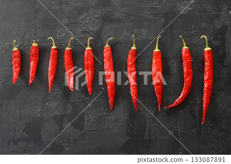 fresh chili peppers on black background,ripe red chili peppers. Top view. Mexican cuisine. 133087891
