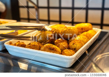 Potatoes baked in their skins in the hotel buffet Potatoes baked in their skins in the hotel buffet 133088046