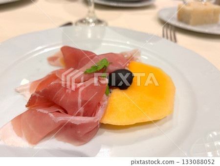 Slices of prosciutto on white plate Slices of prosciutto on white plate 133088052