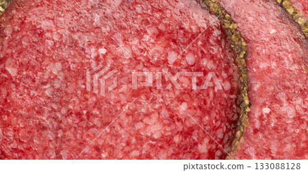 Pepper salami cuts isolated, thin sausage slices. Sliced dry chorizo, sausages round pieces Pepper salami cuts isolated, thin sausage slices. Sliced dry chorizo, sausages round pieces 133088128