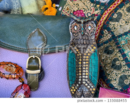 Handmade metal owl decoration with jewelry and fabric. Artisan craft, culture, and bohemian style accessories with ethnic aesthetic. Handmade metal owl decoration with jewelry and fabric. Artisan craft, culture, and bohemian style accessories with ethnic aesthetic. 133088455