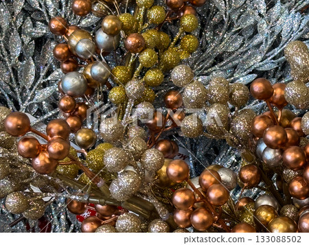 Glitter branches with gold and silver berries for decor. Holiday ornament, festive composition, and elegant Christmas background. Glitter branches with gold and silver berries for decor. Holiday ornament, festive composition, and elegant Christmas background. 133088502