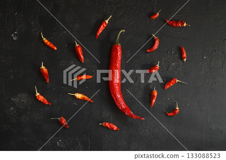 Fresh red hot chili peppers set, on black stone background, top view flat lay, with copy space for text Fresh red hot chili peppers set, on black stone background, top view flat lay, with copy space for text 133088523
