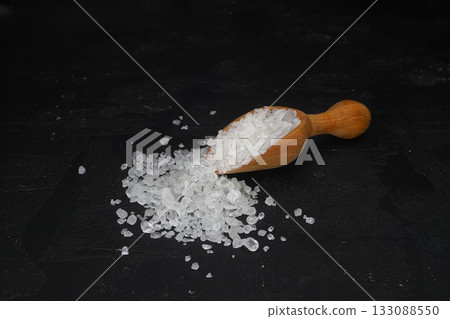 sea salt in a spoon isolated on black background sea salt in a spoon isolated on black background 133088550