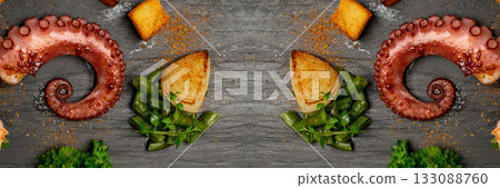 Grilled octopus tentacle on black stone plate served with shrimps 133088760