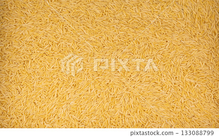 Raw orzo pasta, risoni or kritharaki pile 133088799