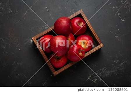 Red apples wooden box autumn harvest fruit dark background fresh healthy 133088891
