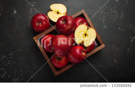 Red apples wooden box autumn harvest fruit dark background fresh healthy 133088892