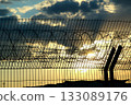 Airport safety fence over cloudy sky stock photo Airport safety fence over cloudy sky stock photo 133089176