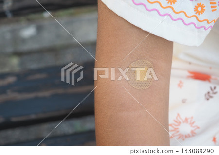 Healing bandage on an child arm after a small injury 133089290