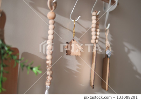 Wooden home charm hanging in a sunny kitchen space 133089291