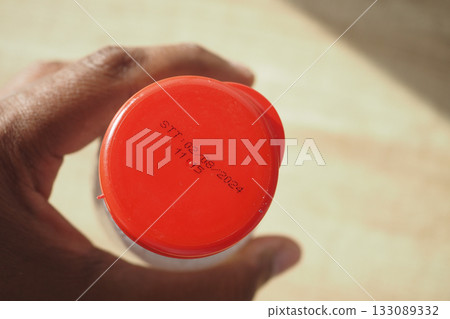 Bottle cap showing expiration date and time information 133089332