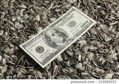 Dollars banknotes and sunflower seeds, oleaginous Commodity value concept. Dollars banknotes and sunflower seeds, oleaginous Commodity value concept. 133089553