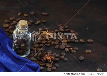 Top view, flat lay roasted coffee beans in glass bottle over pile of beans background, space for your text. Top view, flat lay roasted coffee beans in glass bottle over pile of beans background, space for your text. 133089595