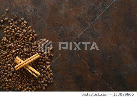 Cinnamon sticks and anise stars spices on roasted coffee beans background. 133089600