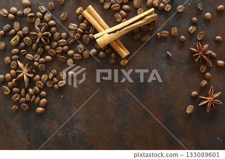 Cinnamon sticks and anise stars spices on roasted coffee beans background. 133089601