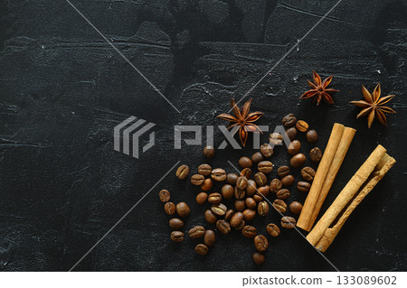 Cinnamon sticks and anise stars spices on roasted coffee beans background. Cinnamon sticks and anise stars spices on roasted coffee beans background. 133089602