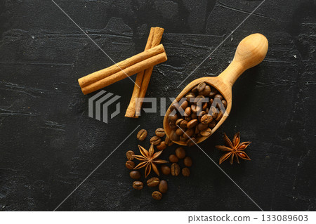 Cinnamon sticks and anise stars spices on roasted coffee beans background. 133089603