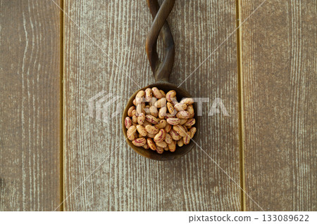 red kidney beans in wooden spoon isolated on dark background. 133089622