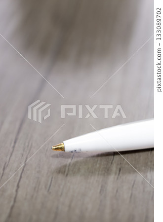 Close-up of a ballpoint pen lying on a table 133089702