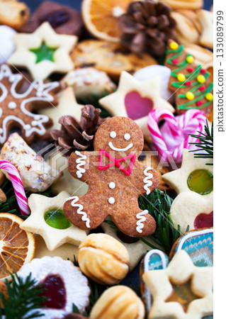Gingerbread man and many different sweet Christmas cookies, close-up, top view, holiday concept 133089799
