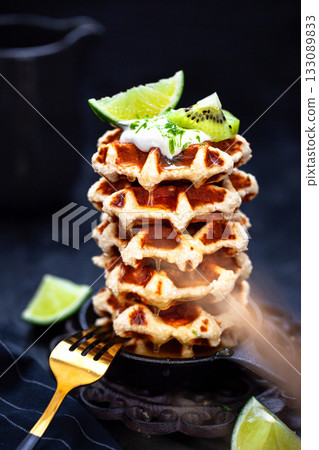 Delicious healthy gluten free coconut wafers, served with honey, kiwi, lime and cream 133089833