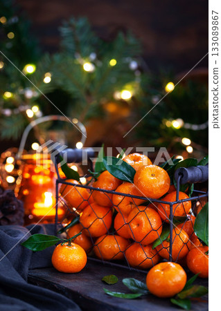 Fresh ripe tangerines with leaves on wooden table Fresh ripe tangerines with leaves on wooden table 133089867
