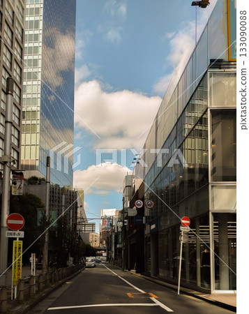 Shinjuku's anime-like alleyway with big clouds and blue skies Shinjuku's anime-like alleyway with big clouds and blue skies 133090088