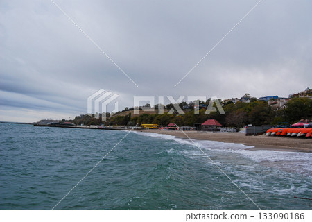 Beautiful seascape of the Black Sea. A seascape of the Black Sea with gentle waves lapping a sandy beach. 133090186