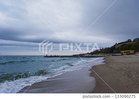 Beautiful seascape of the Black Sea. A seascape of the Black Sea with gentle waves lapping a sandy beach. 133090275
