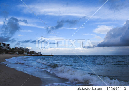 Beautiful seascape of the Black Sea. A seascape of the Black Sea with gentle waves lapping a sandy beach. Beautiful seascape of the Black Sea. A seascape of the Black Sea with gentle waves lapping a sandy beach. 133090440
