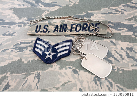 US AIR FORCE branch tape and Senior Airman rank patch and dog tags on digital tiger-stripe pattern Airman Battle Uniform background 133090911