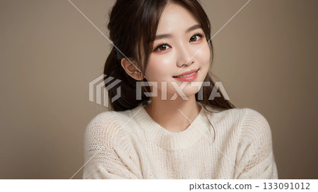 A soft matte background that highlights the woman in a thick white knit. 133091012