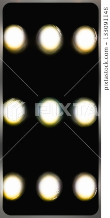 Grid of bright circular lights on a dark background. A grid of nine bright round lights arranged in three rows on a dark background. Grid of bright circular lights on a dark background. A grid of nine bright round lights arranged in three rows on a dark background. 133091148
