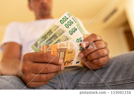 Greenbacks many one hundred euro banknotes and fifty euros fan-shaped in palms of man Greenbacks many one hundred euro banknotes and fifty euros fan-shaped in palms of man 133091338