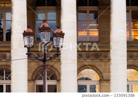 Historic building columns and ornate street lamp in city 133091386
