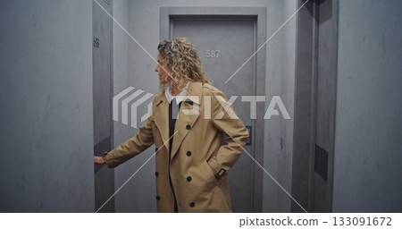 Stylish Female Traveler Leaves Room, Heads Through Quiet Hotel Hallway Stylish Female Traveler Leaves Room, Heads Through Quiet Hotel Hallway 133091672