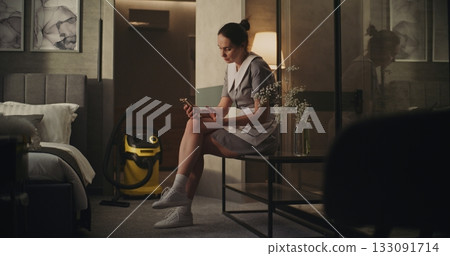 Tired Housekeeping Worker Pauses to Breathe After Cleaning Tired Housekeeping Worker Pauses to Breathe After Cleaning 133091714