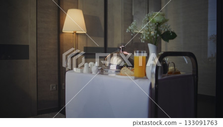 Professional Hotel Employee Delivering Room Service in Upscale Accommodation 133091763