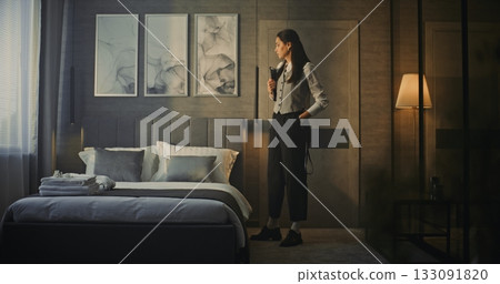 Professional Woman Enters Modern, Luxurious Hotel Room 133091820