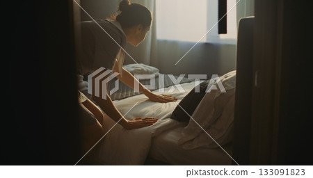 Hotel Room Attendant In Uniform Prepares Accommodation For Next Guest 133091823