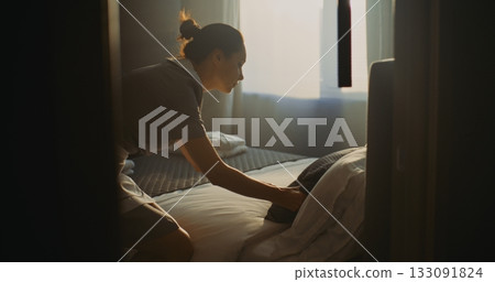Hotel Room Attendant In Uniform Prepares Accommodation For Next Guest Hotel Room Attendant In Uniform Prepares Accommodation For Next Guest 133091824