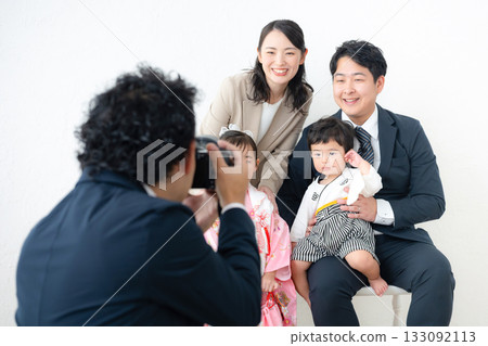 A family and photographer taking family photos indoors for Shichi-Go-San or an anniversary 133092113
