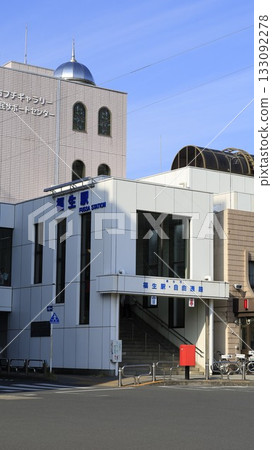 The west exit of Fussa Station on the JR Ome Line, next to a police box 133092278