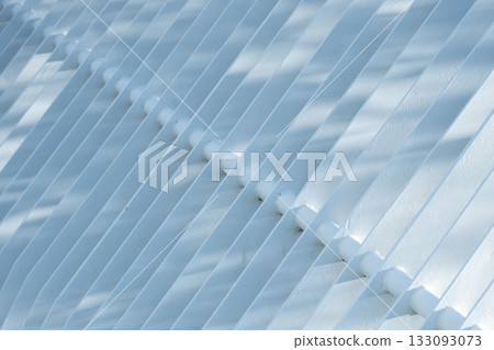 White grille under dappled tree shadows 133093073