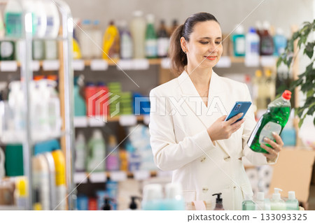 Adult woman scanning qr code for dishwashing 133093325